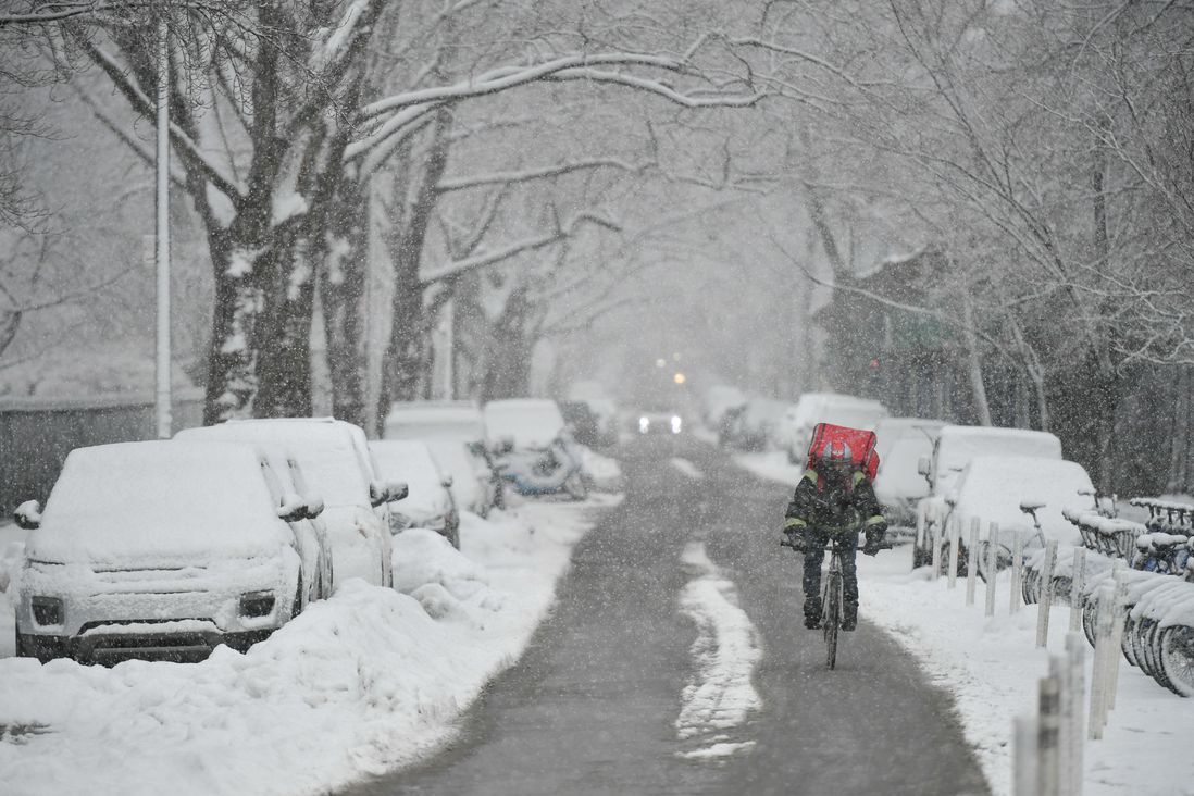 A cyclist rides through the snow by McCarren Park in Greenpoint.